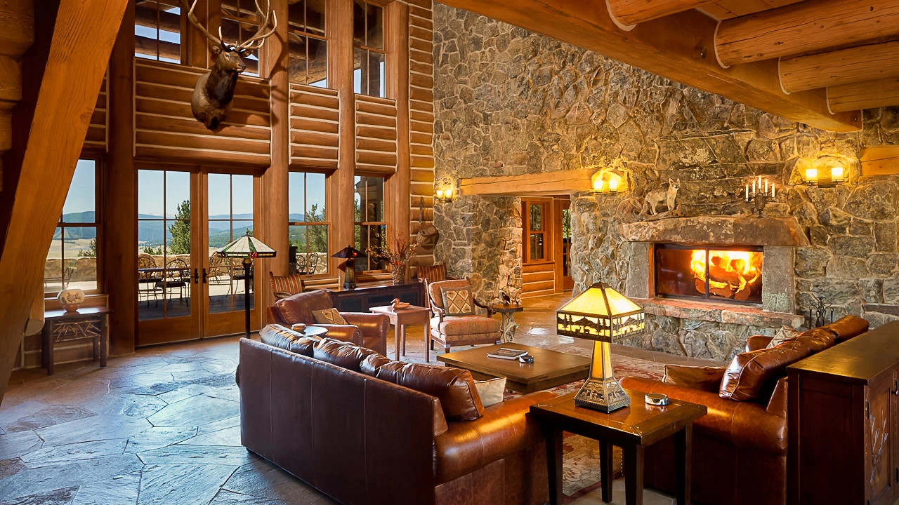 Costilla Lodge interior with stone fireplace and mountain view